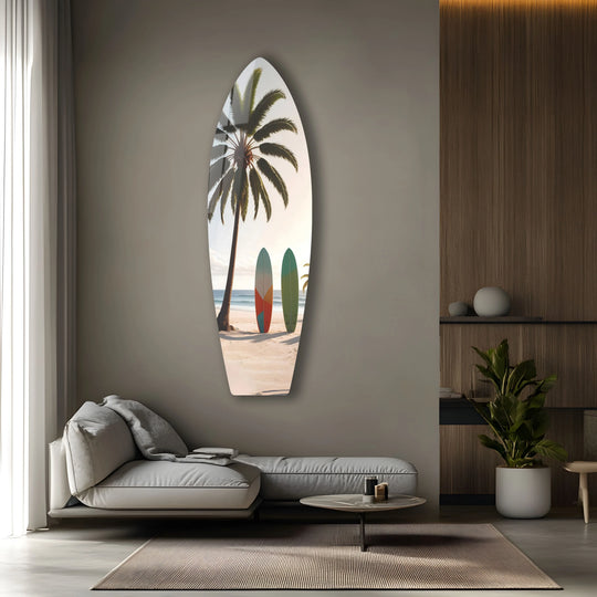 Negative space accentuates the surfboard-shaped glass wall artwork featuring a tropical beach scene with palm trees and surfboards, creating a coastal paradise decor.