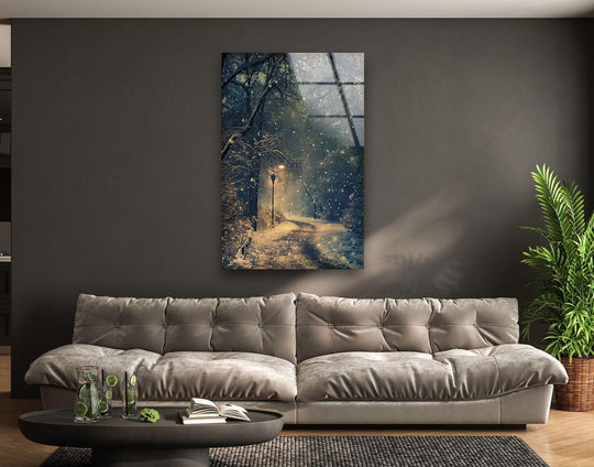 A close-up of the coffee table featuring refreshing beverages and books showcases the serene 'Snowy Forest Path With Lantern' art from glass in the background.