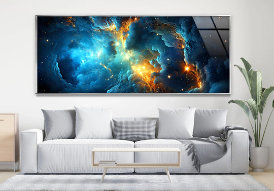 Foreground shows a soft rug, a contemporary coffee table with books, and a white sofa beneath the Blue&Orange Galaxy abstract print wall art.