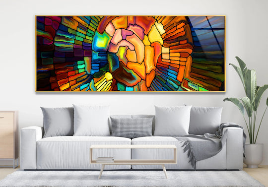 Colorful stained glass wall art features an abstract design and vibrant colors and is a modern statement piece above a sofa