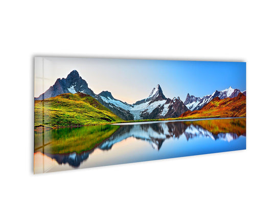Lake Bachalpsee glass wall art showcases a scenic mountain landscape and vibrant reflections and is a stunning panoramic piece for large wall decor