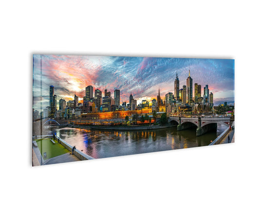 Serene home decor is evoked in this cityscape glass wall art, featuring the illuminated skyline of downtown Melbourne reflected in the still river at twilight.