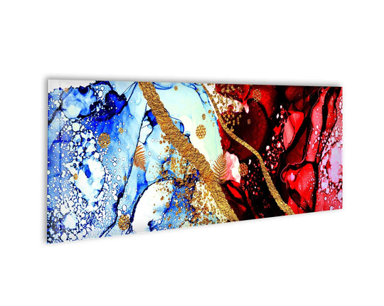 Red and blue ink abstract glass wall art features gold accents and a flowing design and is a vibrant panoramic statement piece