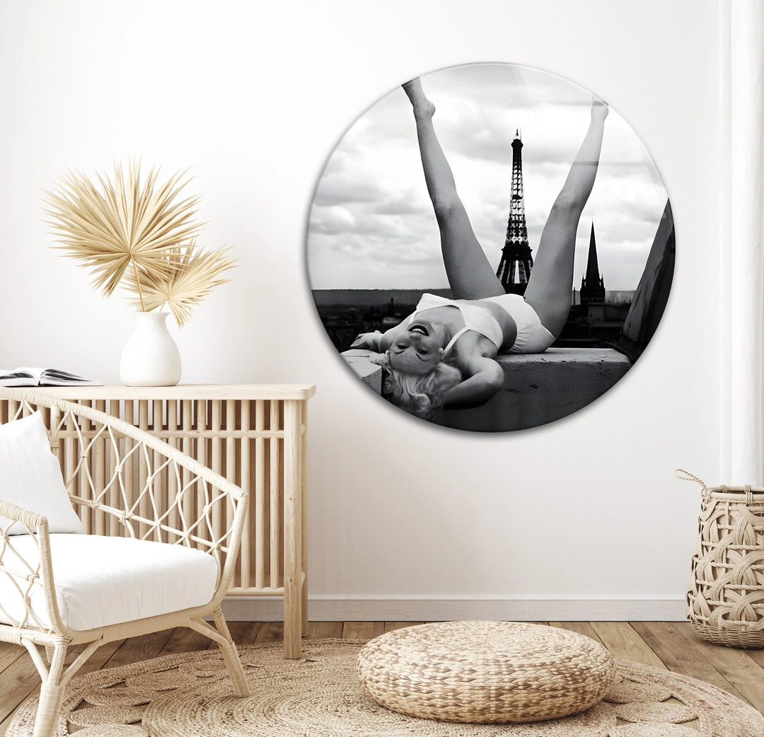 Elegant black and white glass art of a woman stretched out with the Eiffel Tower in the distance.