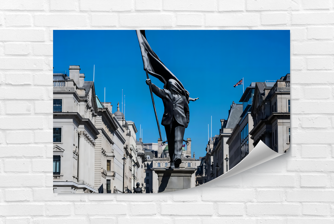 The curled bottom right edge of this modern Banksy glass wall art decor showcases a freedom march statue under a clear blue sky.