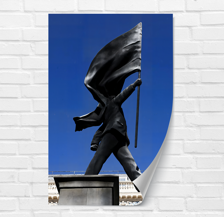 The foreground's textured white brick wall showcases striking Banksy glass wall art decor, its bottom right corner gently peeling.