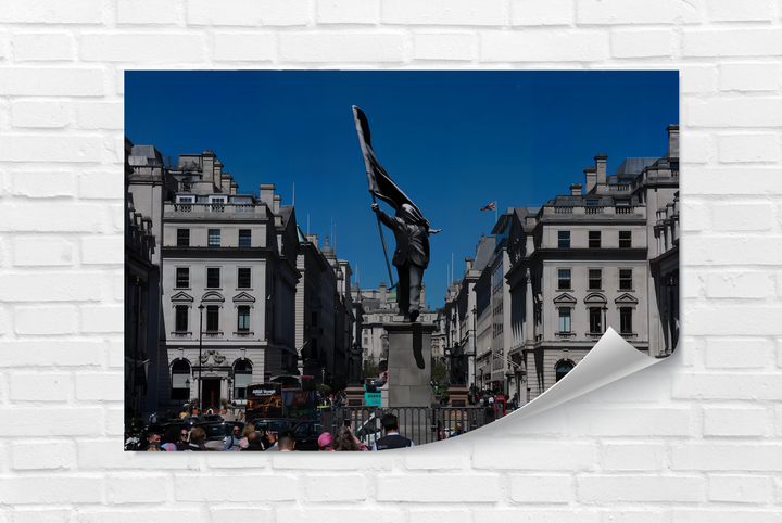 The central statue of a man in a suit holding billowing fabric against a vibrant blue sky in London, perfect for modern decorative wall art.