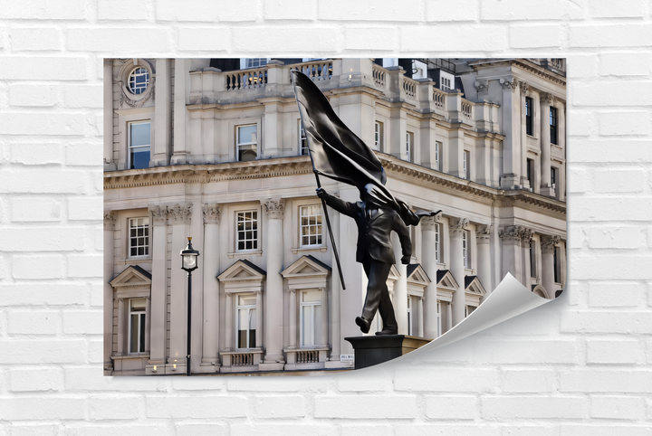 The iconic Stride of Freedom Statue, a man holding a flag, captured as unique art from glass against grand classical architecture.