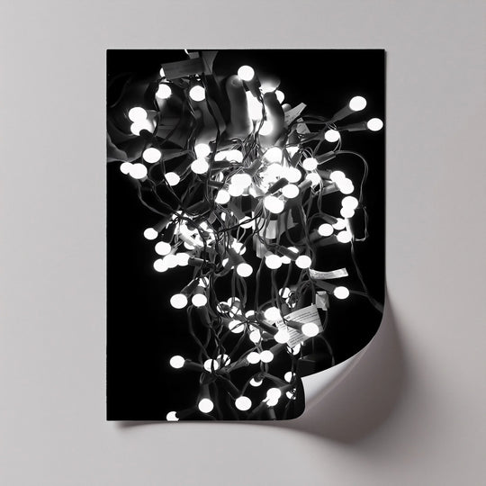 Dramatic light and shadow play across this abstract black and white canvas wall art, highlighting the luminous tangle of bulbs in a bold design.