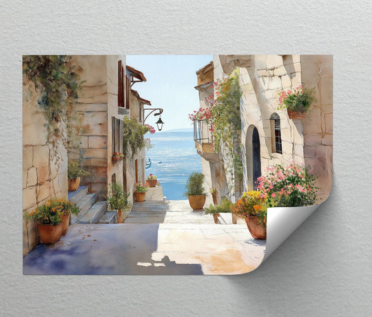 Vibrant floral pots accentuate the foreground detail of this sunlit coastal alley canvas art prints, offering a picturesque Mediterranean sea view.