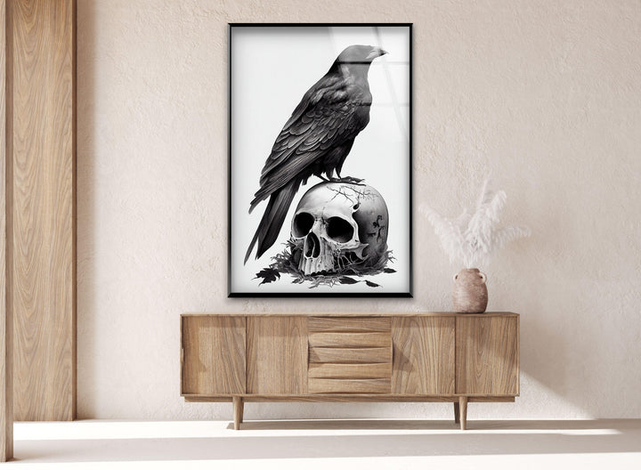 Detailed raven illustration perched on a skull rendered in high-contrast grayscale on tempered glass.