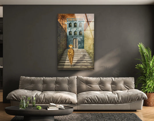 Glass wall art featuring a figure in ochre walking up a stairway toward a building with a muted gray facade, accented by earthy tones.