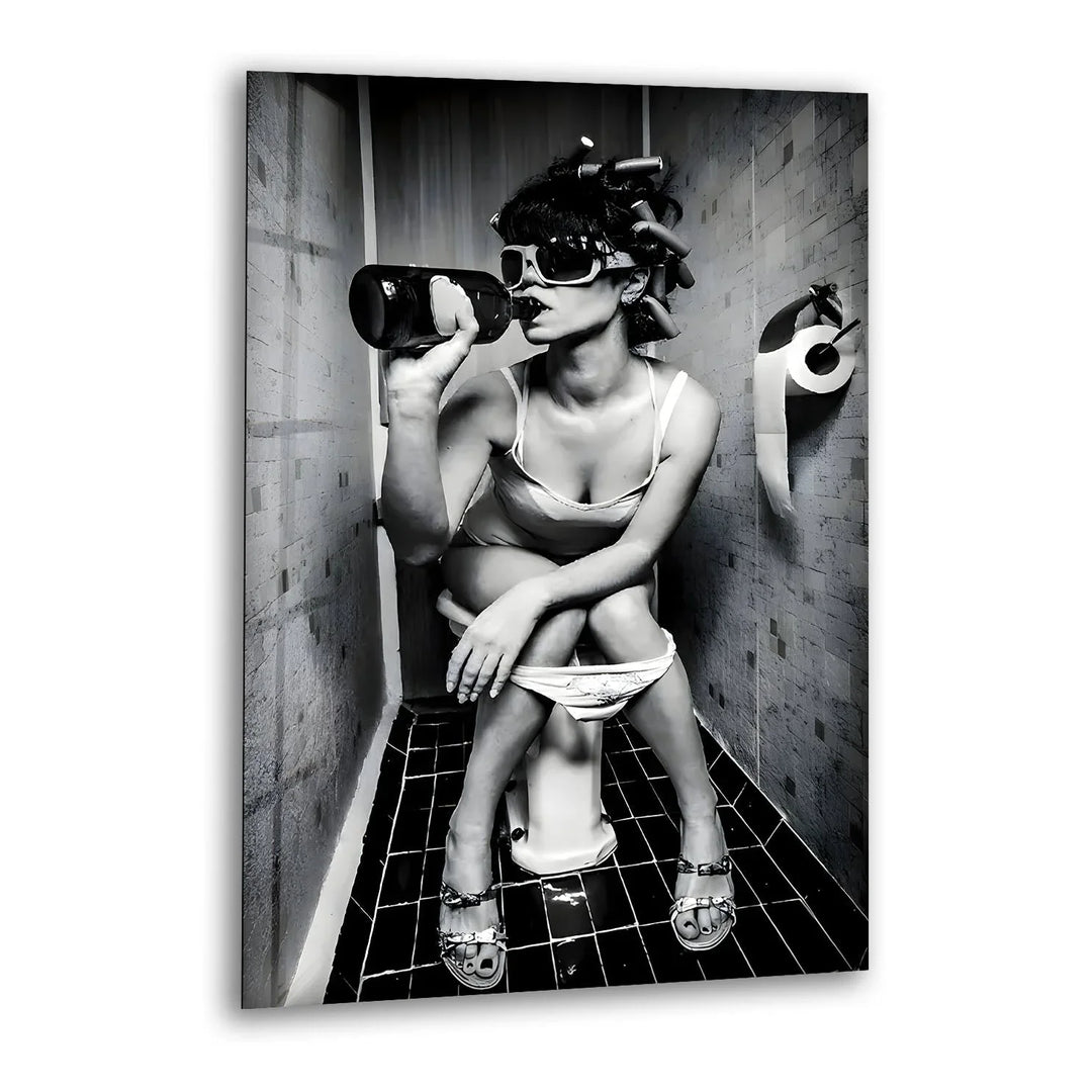 Black and white glass wall art featuring a retro-styled woman in sunglasses sitting casually in a small tiled bathroom.