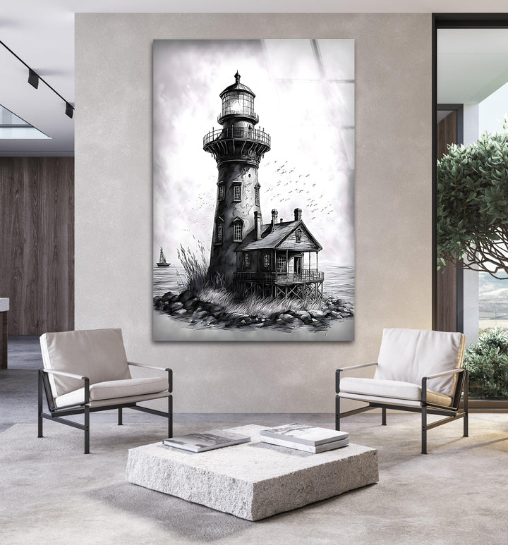 Black and white glass artwork of a tall lighthouse rising above a rocky shoreline.