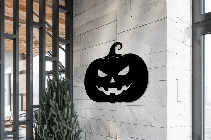 Halloween-themed jack-o’-lantern metal wall décor piece