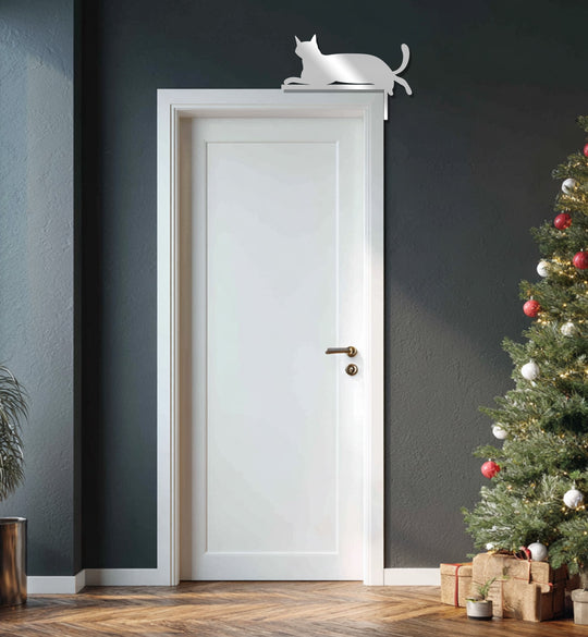Light and shadow play on the relaxed cat decoration wall art, a sleek metal silhouette casting a subtle shade on the doorframe.