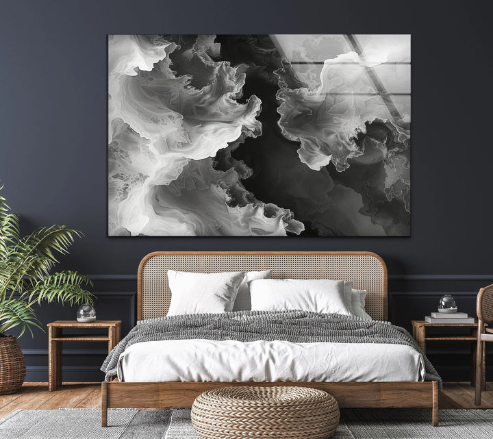 Artistic black and white glass panel showcasing fluid swirling forms for modern minimalist decor.