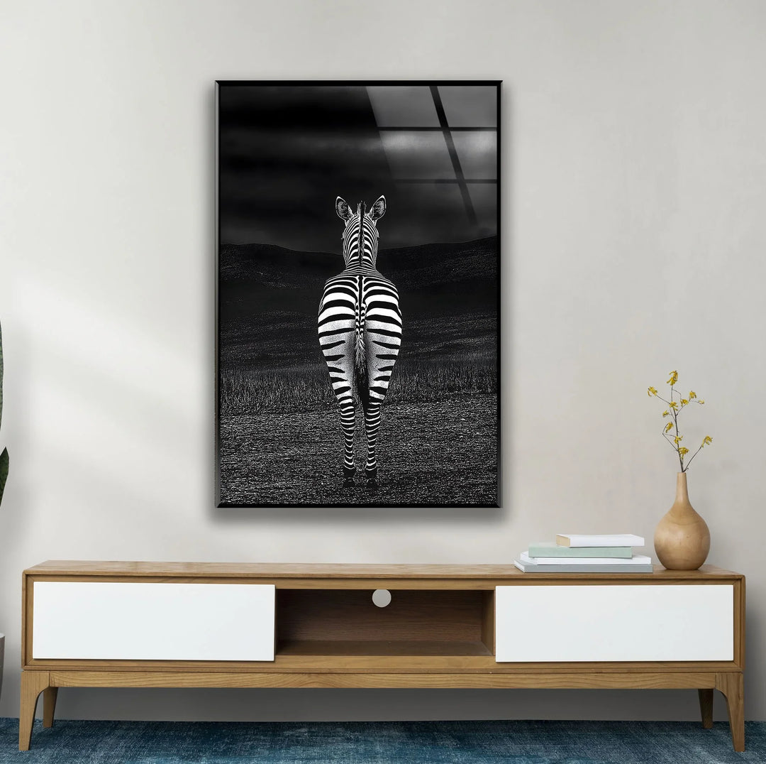 Black and white zebra artwork on glass highlighting bold stripes with a dark, atmospheric backdrop.