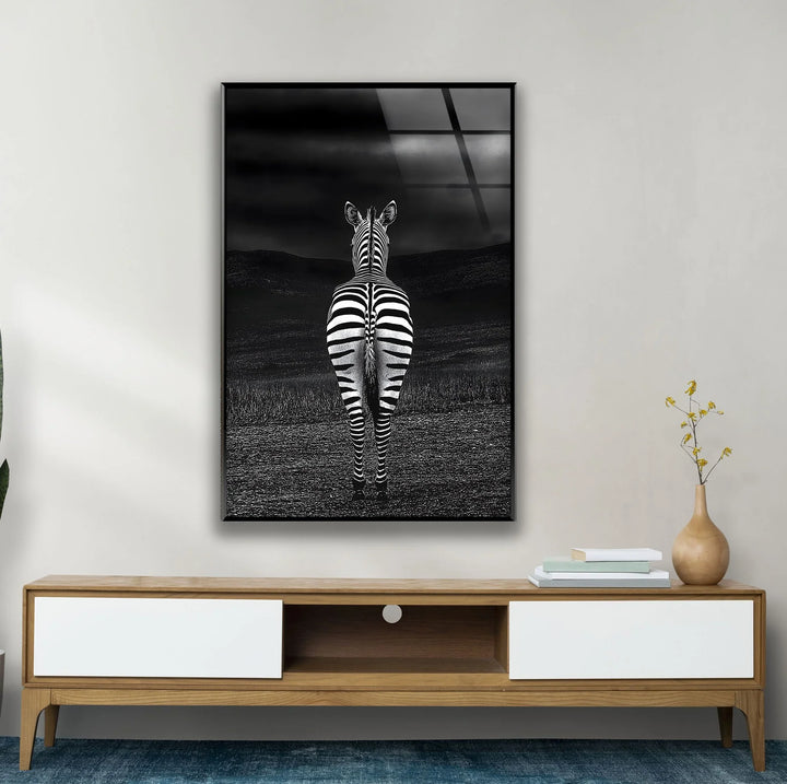 Black and white zebra artwork on glass highlighting bold stripes with a dark, atmospheric backdrop.