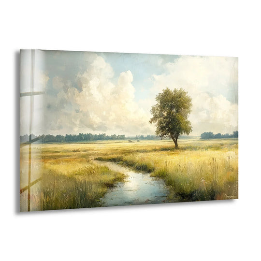 Tranquil golden meadow landscape evokes a serene mood with a solitary tree and stream depicted in this stunning glass wall artwork.