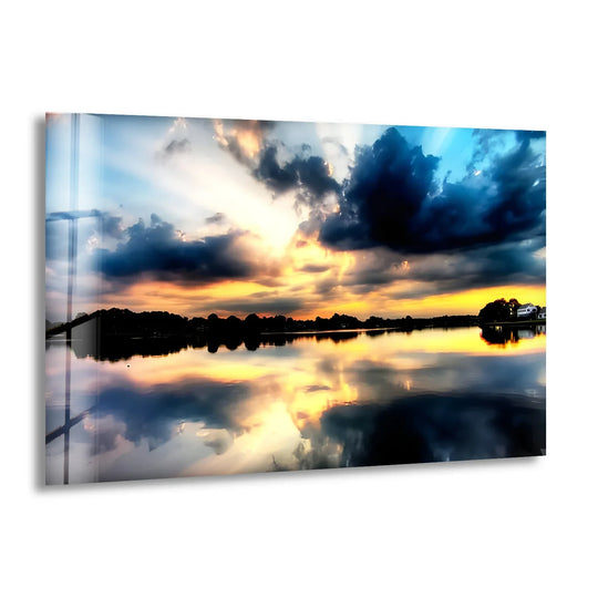 The focal point of the 'Reflections of Heaven' sunset lake glass wall art captures a serene home decoration through the golden sunset reflecting on the calm water's surface.