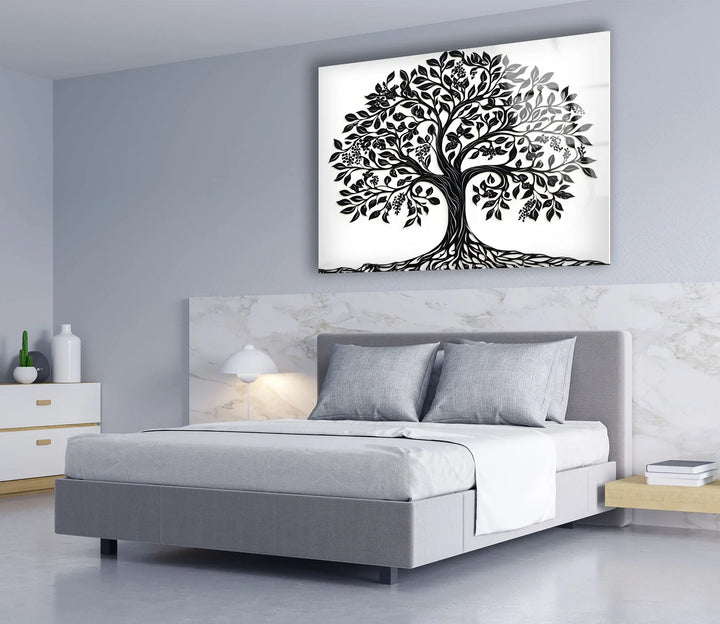 Black and white artistic tree illustration on glass emphasizing detailed foliage and intertwined roots.
