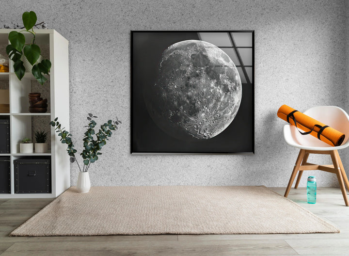 Minimalist black and white moon artwork on glass showing a large, textured lunar sphere.