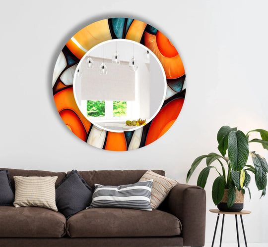 The orange stained round wall mirror features an abstract design and it is a decorative living room mirror and a colorful glass round mirror for home decor