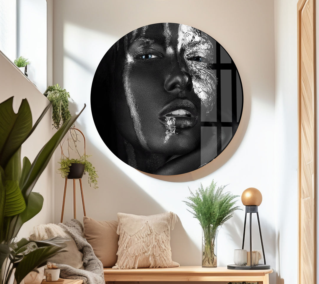 Artistic black and white close-up on glass featuring shimmering silver textures and bright blue eyes.