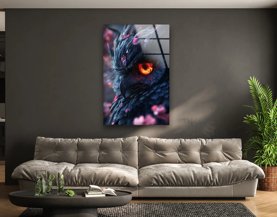 A striking glass wall art print showcases an owl's intense fiery eye and detailed feathers.