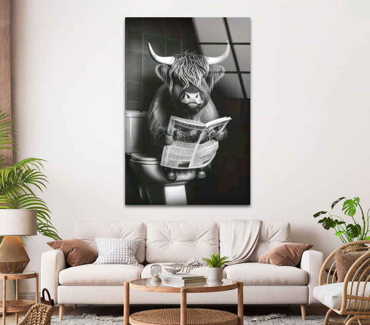 Funny grayscale wall art depicting a fluffy cow with bangs sitting on a toilet and reading.