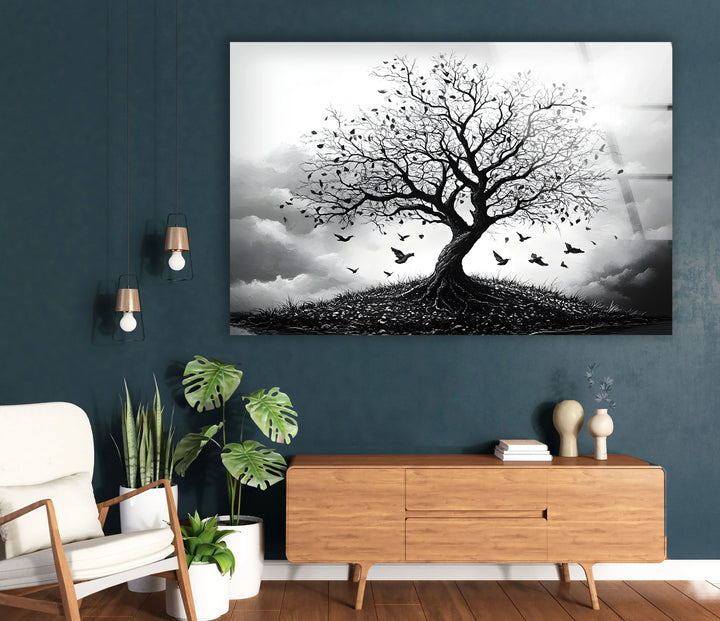 Black and white glass wall print capturing the silhouette of a tree with birds circling overhead.