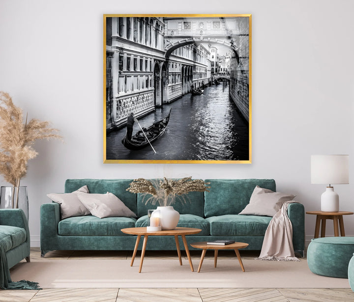Monochrome depiction of Venice’s waterways with a gondolier beneath an arched bridge.