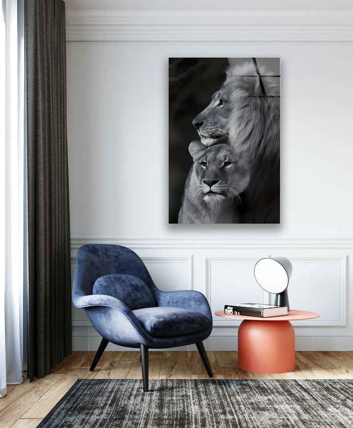 Black and white wildlife glass wall art portraying a tender moment between a lion pair.