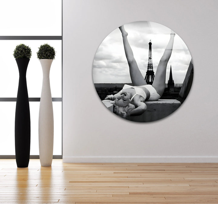Monochrome artwork on glass of a woman posing joyfully with iconic Paris architecture.