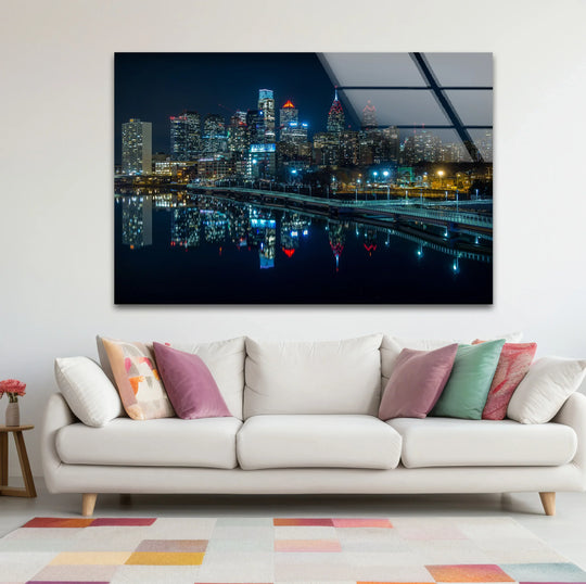 Illuminated reflections on the Philadelphia skyline emphasize the brightest area in this tempered glass wall art, showcasing the city's vibrant nighttime architecture.