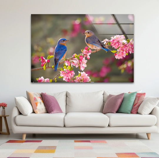 This glass printing captures the warm, inviting color temperature of spring with vibrant bluebirds and soft pink blossoms.
