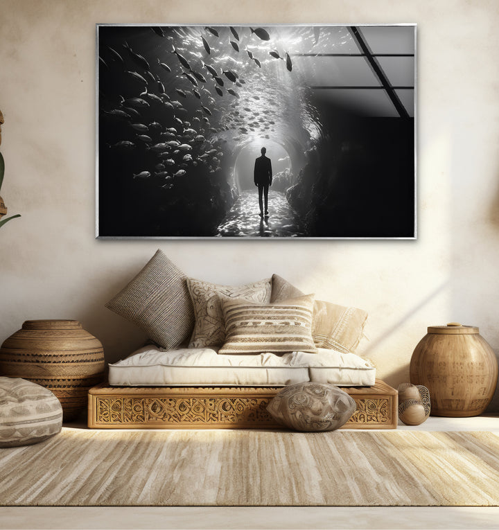 Timeless black and white wall art capturing the dreamlike moment of a man in an aquarium tunnel.