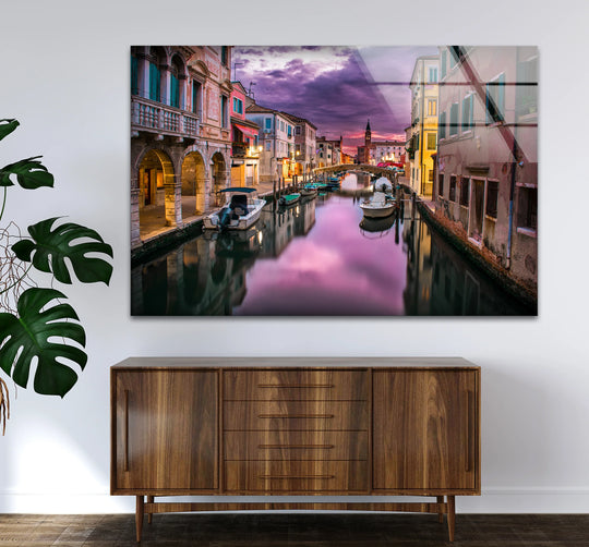 Showcasing the layering effect, the Venice canal scene with sunset reflections is emphasized through hanging wall art on glass, complemented by the depth of canal reflections.