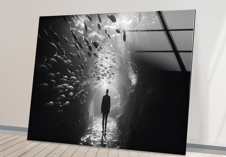 Bold black and white abstract art featuring the surreal imagery of an aquarium and a lone figure.