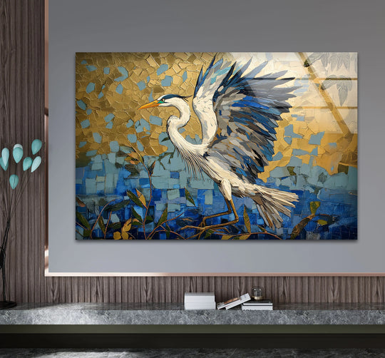 A magnificent glass art heron with textured gold and blue mosaic wings soars over rippling water with leaf accents.