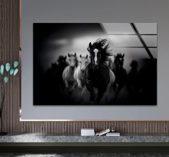 Dynamic black and white running horses glass wall art, best glass art capturing the focal point of a lead stallion with flowing mane.