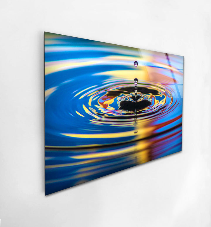 Modern abstract glass wall decor showcasing a water droplet creating dynamic ripples.
