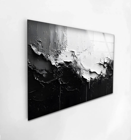 A modern abstract black and white glass printing showcases textured edges and borders creating a bold contrast.