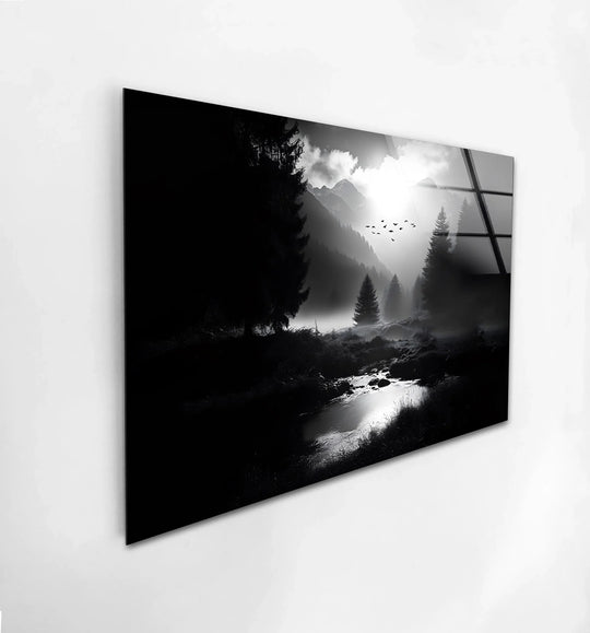 Cool color temperature highlights a serene, black and white mystic mountain landscape with a dreamy river, showcased as hanging wall art on glass.
