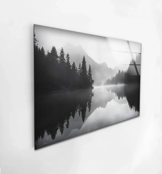 Smooth surface texture highlights the misty mountain reflection in this black and white glass wall art, a piece of unique modern wall decor.