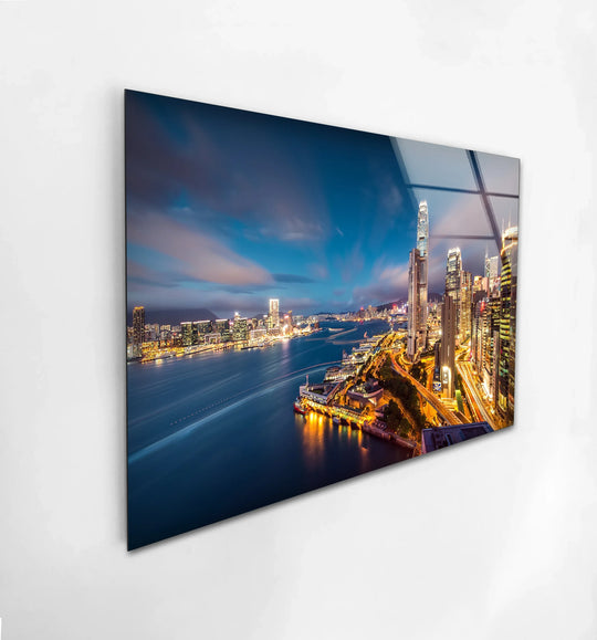 Enchanting mood emanates from this illuminated Hong Kong cityscape on tempered glass wall art, depicting the skyline's mesmerizing waterfront and nighttime glow.