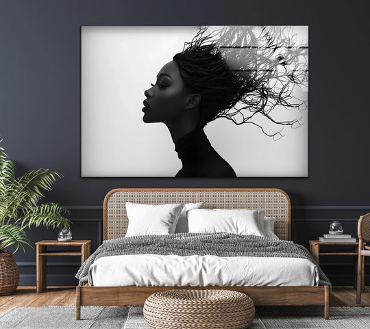 A horizontal, rectangular glass wall art decor of an abstract black and white profile portrait of a woman with flowing hair.