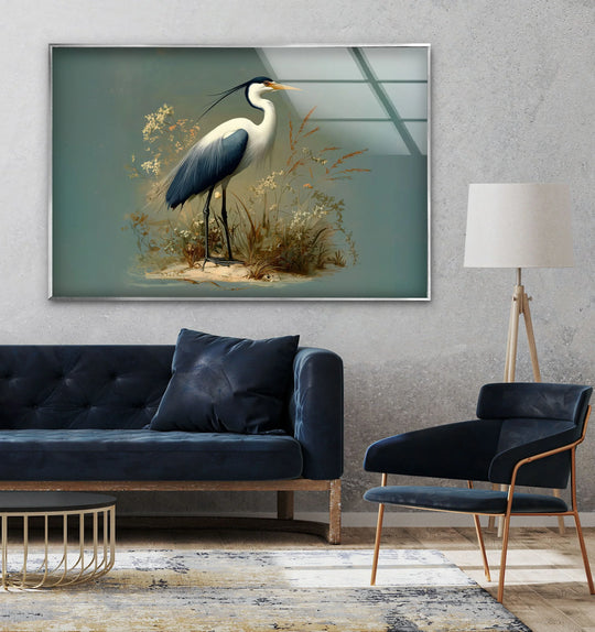 A still heron stands calmly amidst wildflowers on this elegant glass wall art decor.
