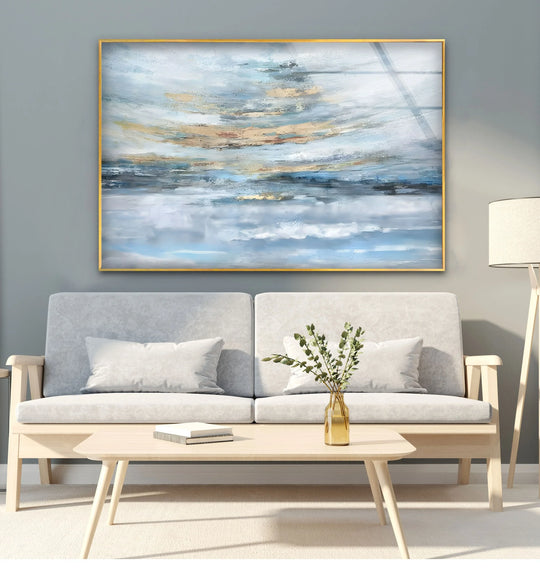 Abstract gold and blue tones create a tranquil focal point in this seascape horizon art from glass, offering a modern coastal aesthetic for any living space.